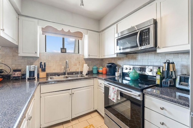 16841 Heritage Bay Rd Unit E-4, Rogers, AR 72756 - kitchen with stainless steel appliances, dark countertops, and white cabinets