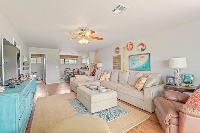16841 Heritage Bay Rd Unit E-4, Rogers, AR 72756 - living area featuring light wood-style floors and ceiling fan