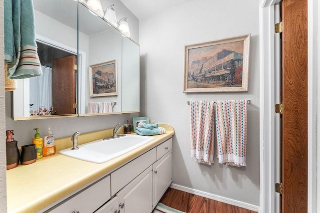 16841 Heritage Bay Rd Unit E-4, Rogers, AR 72756 - bathroom with vanity and wood finished floors