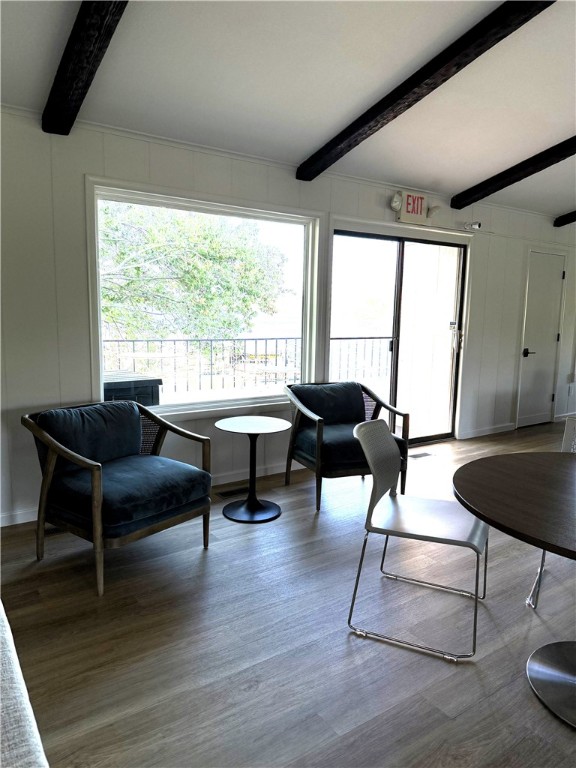 16841 Heritage Bay Rd Unit E-4, Rogers, AR 72756 - living area with beam ceiling, wood finished floors, and a decorative wall