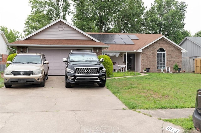 1013 N 26th St, Rogers, AR 72756 - single story home featuring concrete driveway, roof mounted solar panels, brick siding, and an attached garage