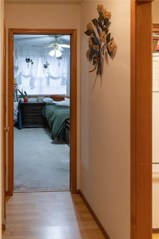 1013 N 26th St, Rogers, AR 72756 - hallway featuring light wood-style floors and light colored carpet
