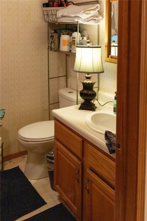 1013 N 26th St, Rogers, AR 72756 - bathroom featuring vanity and wallpapered walls