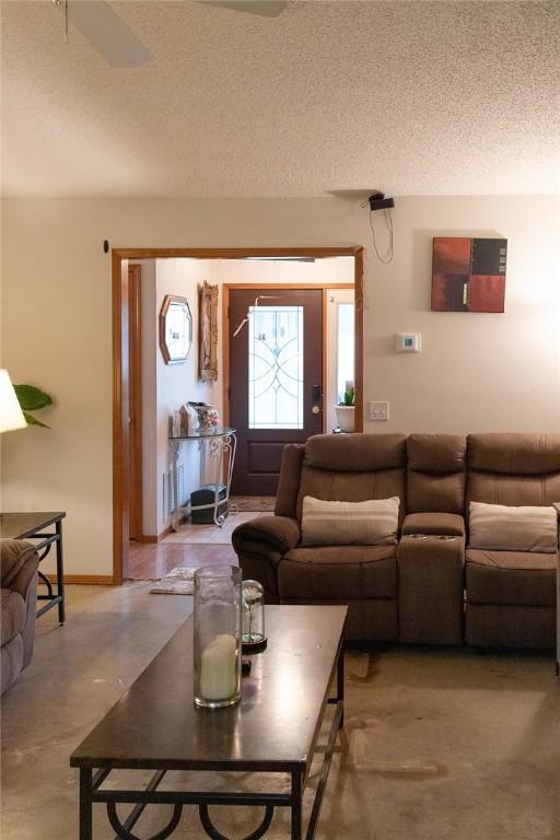 1013 N 26th St, Rogers, AR 72756 - living room featuring a textured ceiling and finished concrete floors