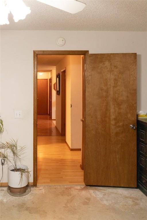 1013 N 26th St, Rogers, AR 72756 - hallway featuring a textured ceiling and light wood-style floors
