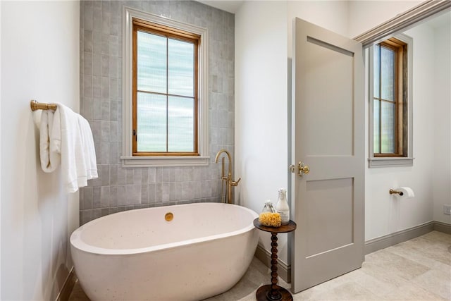 300 NW 5th St, Bentonville, AR 72712 - full bathroom with a soaking tub and baseboards