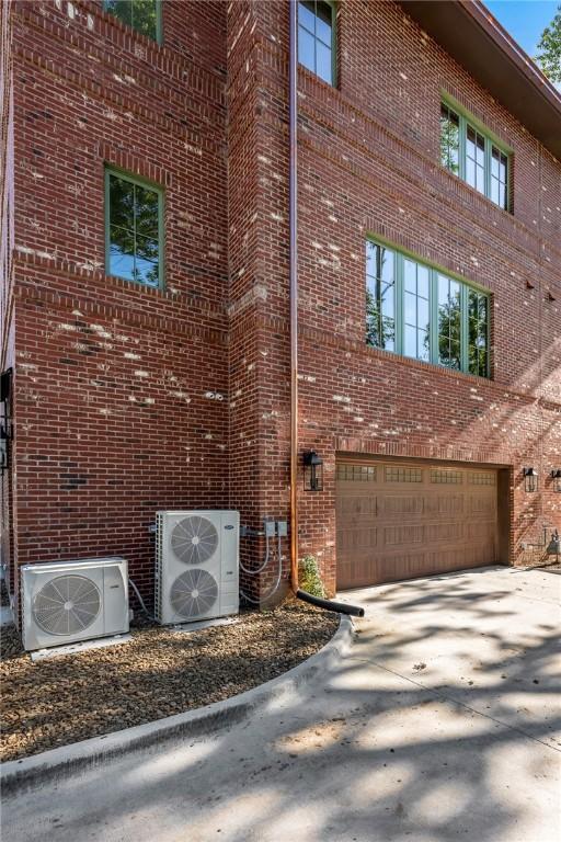 300 NW 5th St, Bentonville, AR 72712 - view of property with an attached garage and concrete driveway