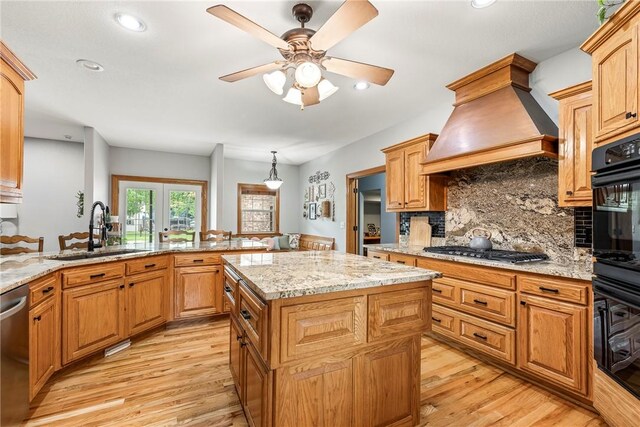 2 Conner Ln, Rogers, AR 72756 - kitchen with appliances with stainless steel finishes, custom exhaust hood, light wood-style flooring, decorative backsplash, and recessed lighting