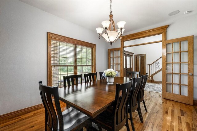 2 Conner Ln, Rogers, AR 72756 - dining room featuring a chandelier, light wood-style floors, and stairway