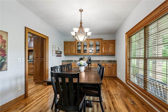 2 Conner Ln, Rogers, AR 72756 - dining area featuring a chandelier and light wood-style floors