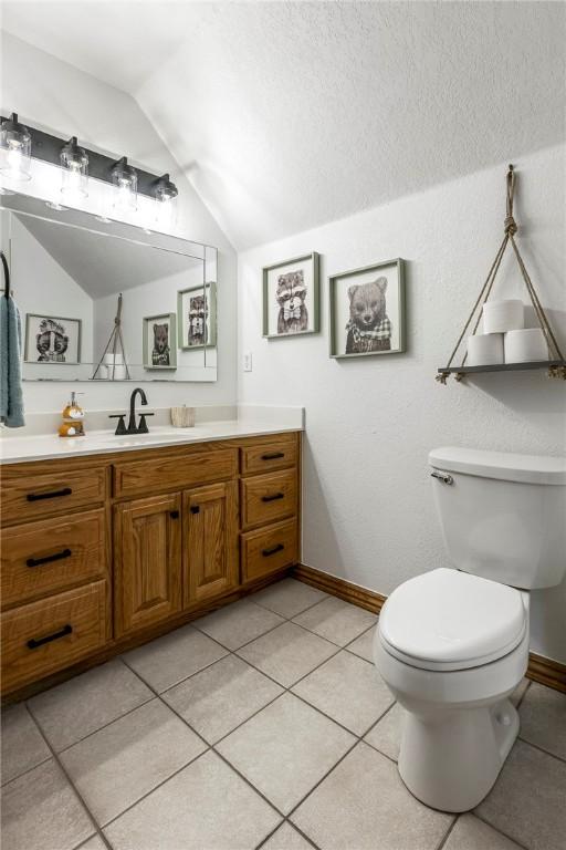 2 Conner Ln, Rogers, AR 72756 - half bathroom featuring lofted ceiling, vanity, and tile patterned flooring