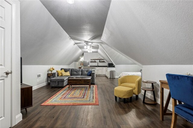 2 Conner Ln, Rogers, AR 72756 - living area featuring a textured ceiling, dark wood-type flooring, ceiling fan, and lofted ceiling