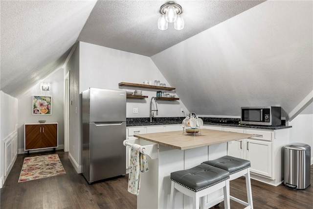 2 Conner Ln, Rogers, AR 72756 - kitchen with stainless steel appliances, butcher block counters, vaulted ceiling, open shelves, and dark wood-style floors