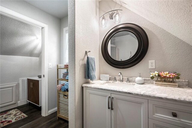 2 Conner Ln, Rogers, AR 72756 - bathroom featuring wood finished floors, vanity, and a textured wall