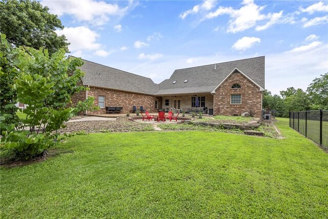 2 Conner Ln, Rogers, AR 72756 - rear view of house featuring a patio, brick siding, and a shingled roof