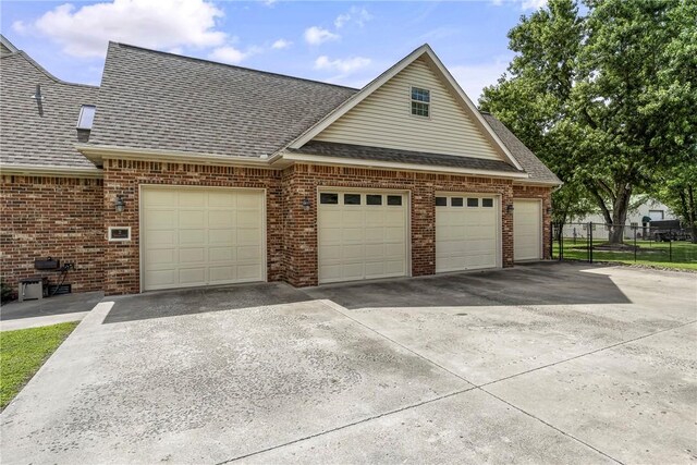 2 Conner Ln, Rogers, AR 72756 - view of front facade featuring roof with shingles, brick siding, concrete driveway, and a garage