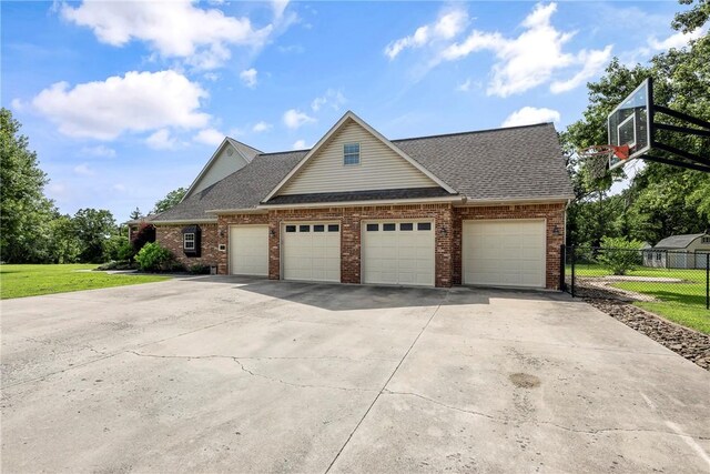 2 Conner Ln, Rogers, AR 72756 - view of front facade featuring brick siding, an attached garage, roof with shingles, and driveway