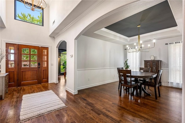 5100 SW Blaire Mont Rd, Bentonville, AR 72713 - dining room with a chandelier, arched walkways, dark wood finished floors, a raised ceiling, and crown molding