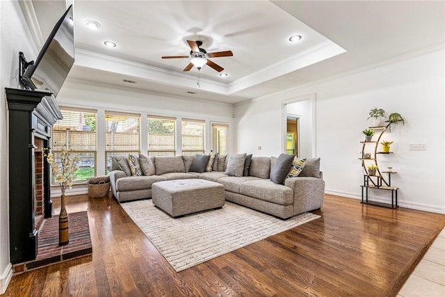 5100 SW Blaire Mont Rd, Bentonville, AR 72713 - living area with crown molding, a ceiling fan, a tray ceiling, wood finished floors, and recessed lighting