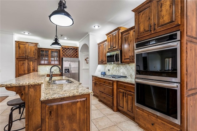 5100 SW Blaire Mont Rd, Bentonville, AR 72713 - kitchen with appliances with stainless steel finishes, light tile patterned floors, arched walkways, backsplash, and light stone countertops