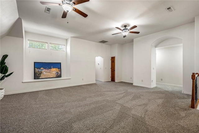 5100 SW Blaire Mont Rd, Bentonville, AR 72713 - unfurnished living room featuring a ceiling fan, arched walkways, and carpet floors
