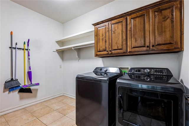 5100 SW Blaire Mont Rd, Bentonville, AR 72713 - laundry area featuring independent washer and dryer, cabinet space, and light tile patterned floors