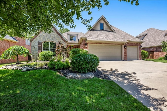 5100 SW Blaire Mont Rd, Bentonville, AR 72713 - view of front of house with an attached garage, driveway, a front yard, a shingled roof, and brick siding