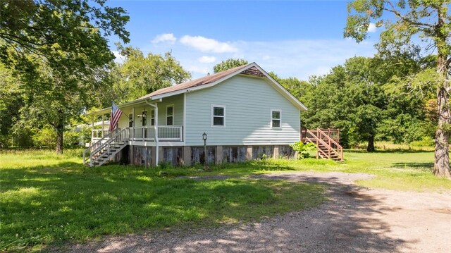 234 N Kibler Hwy, Alma, AR 72921 - view of side of property featuring stairs, covered porch, and a lawn