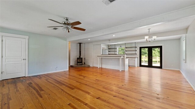 234 N Kibler Hwy, Alma, AR 72921 - unfurnished living room featuring a wood stove, french doors, light wood-style floors, a ceiling fan, and recessed lighting
