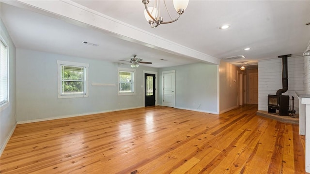 234 N Kibler Hwy, Alma, AR 72921 - unfurnished living room with light wood-type flooring, a wood stove, a chandelier, recessed lighting, and a ceiling fan
