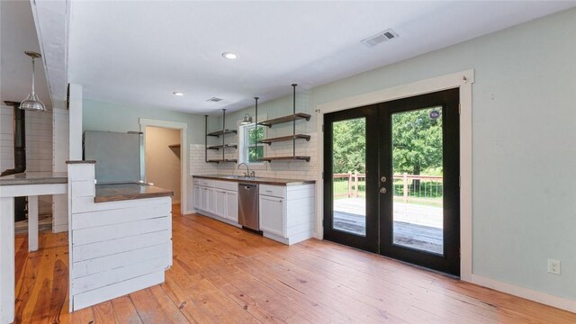 234 N Kibler Hwy, Alma, AR 72921 - kitchen featuring freestanding refrigerator, french doors, stainless steel dishwasher, open shelves, and light wood-style flooring