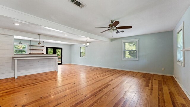 234 N Kibler Hwy, Alma, AR 72921 - unfurnished living room featuring hardwood / wood-style floors, plenty of natural light, ceiling fan, beamed ceiling, and a chandelier
