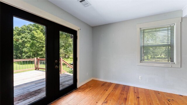 234 N Kibler Hwy, Alma, AR 72921 - doorway with french doors and light wood-style flooring