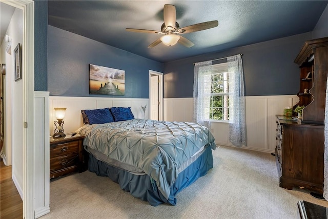 16101 Hickory Dr, Rogers, AR 72756 - bedroom featuring a wainscoted wall, carpet, a ceiling fan, and a decorative wall