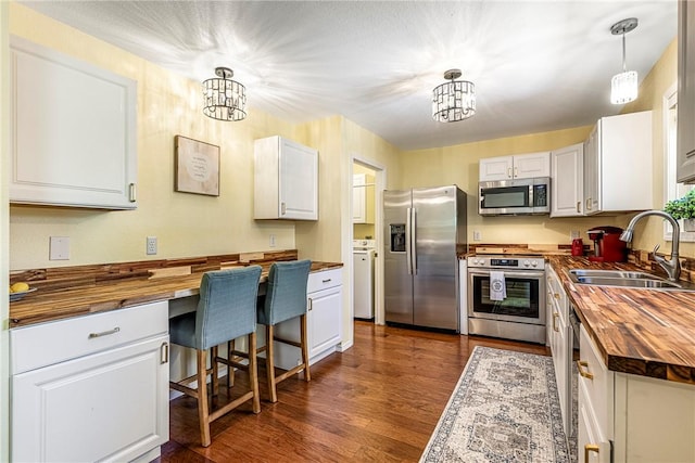 16101 Hickory Dr, Rogers, AR 72756 - kitchen featuring wood counters, appliances with stainless steel finishes, a chandelier, and white cabinetry