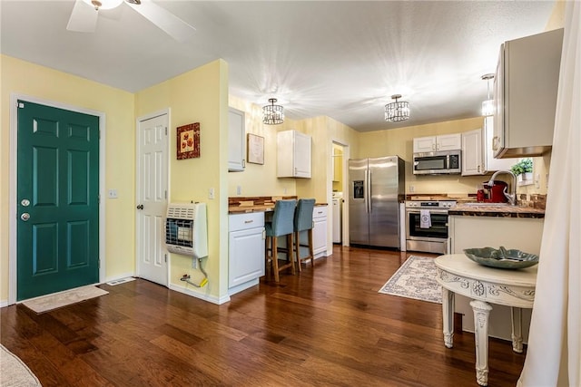 16101 Hickory Dr, Rogers, AR 72756 - kitchen featuring appliances with stainless steel finishes, heating unit, dark wood-style flooring, and ceiling fan