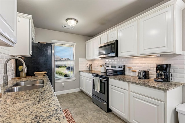 3900 SW Capstone Ave, Bentonville, AR 72712 - kitchen with appliances with stainless steel finishes, white cabinetry, backsplash, and light stone counters