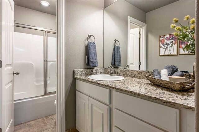 3900 SW Capstone Ave, Bentonville, AR 72712 - full bathroom with vanity, shower / bath combination with glass door, and tile patterned flooring