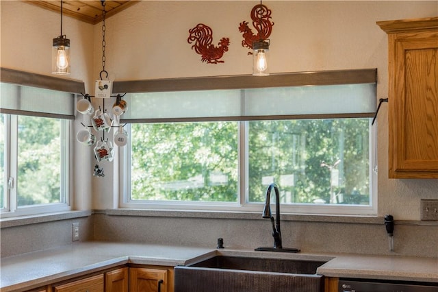 8252 Larue Rd, Rogers, AR 72756 - kitchen with dishwashing machine, light countertops, brown cabinets, and hanging light fixtures