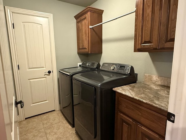 3115 SW Warberry Ave, Bentonville, AR 72713 - laundry room featuring cabinet space, washing machine and clothes dryer, and light tile patterned floors