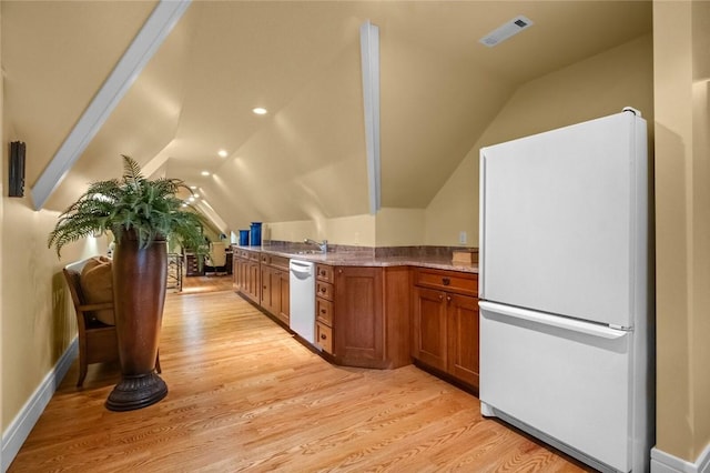 150 Jackson Cove Cres, Eureka Springs, AR 72631 - kitchen with white appliances, vaulted ceiling, brown cabinetry, and light wood finished floors