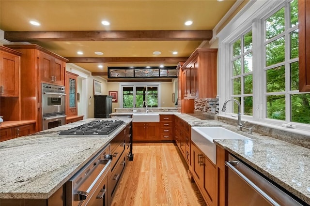 150 Jackson Cove Cres, Eureka Springs, AR 72631 - kitchen with stainless steel appliances, a warming drawer, light wood-style floors, brown cabinetry, and recessed lighting
