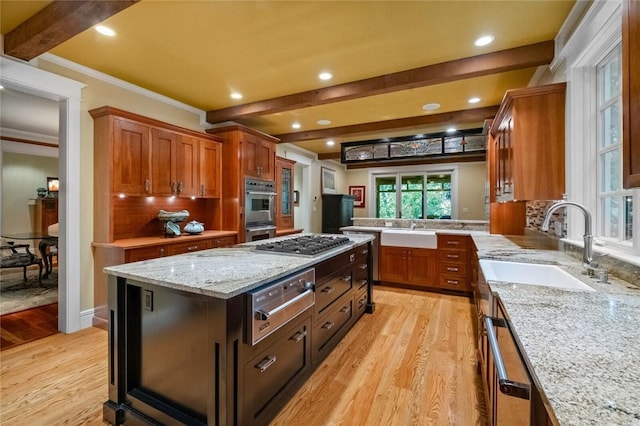 150 Jackson Cove Cres, Eureka Springs, AR 72631 - kitchen featuring a warming drawer, beam ceiling, light wood-type flooring, appliances with stainless steel finishes, and crown molding