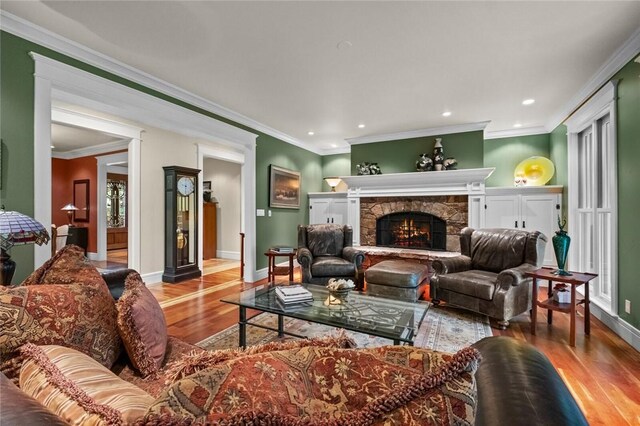 150 Jackson Cove Cres, Eureka Springs, AR 72631 - living room with wood finished floors, recessed lighting, a stone fireplace, and ornamental molding
