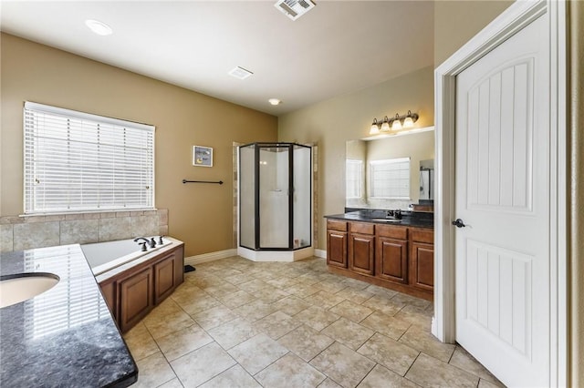 216 Windsor Ave, Lowell, AR 72745 - full bathroom with vanity, a stall shower, and a garden tub