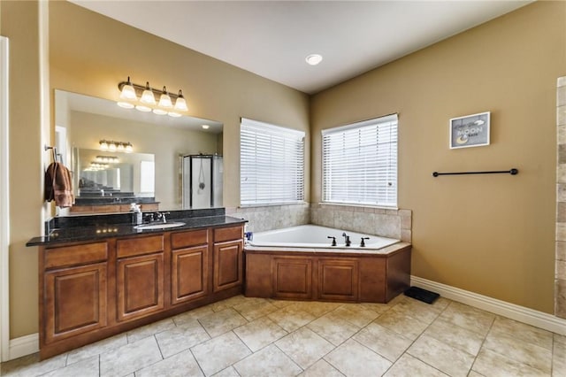 216 Windsor Ave, Lowell, AR 72745 - full bathroom with plenty of natural light, vanity, a garden tub, and a walk in shower