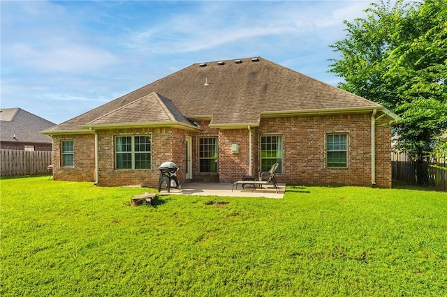 216 Windsor Ave, Lowell, AR 72745 - back of house with a fenced backyard, a patio area, a shingled roof, and brick siding