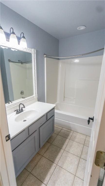 404 NE Whitney St, Bentonville, AR 72712 - bathroom featuring tile patterned flooring, vanity, and tub / shower combination