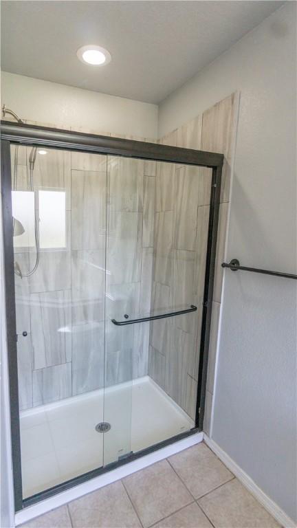 404 NE Whitney St, Bentonville, AR 72712 - bathroom with a stall shower and tile patterned flooring