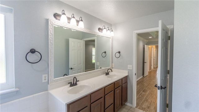404 NE Whitney St, Bentonville, AR 72712 - bathroom featuring double vanity and wood finished floors